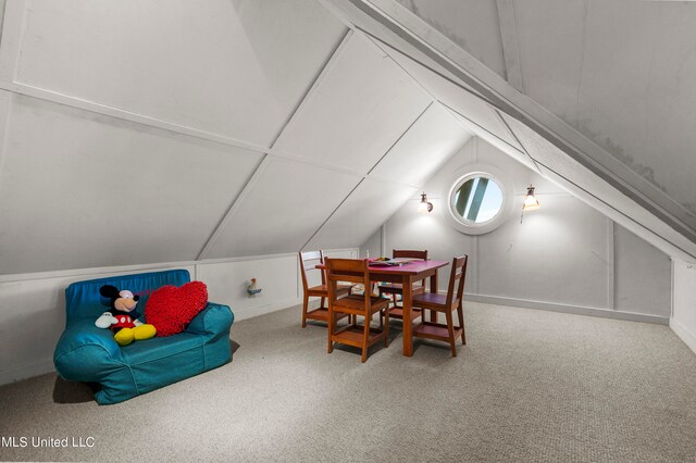 interior space featuring carpet flooring and lofted ceiling