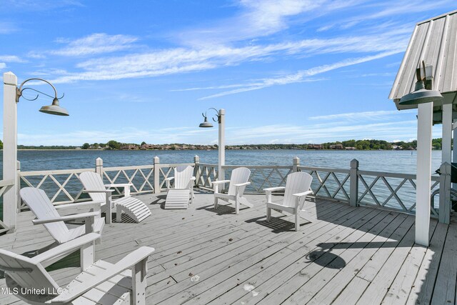 dock area featuring a deck with water view