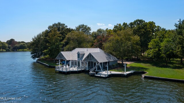 dock area with a yard and a water view