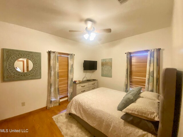 bedroom with ceiling fan and light hardwood / wood-style flooring