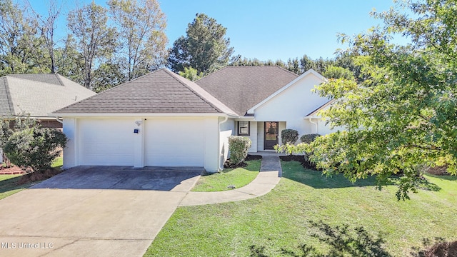 single story home featuring a front lawn and a garage