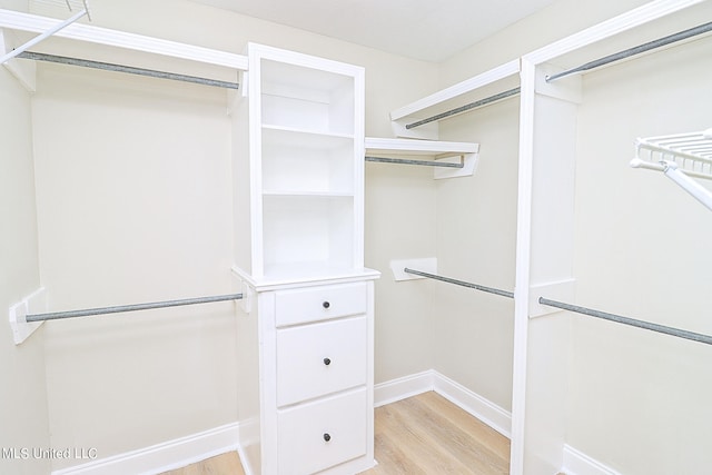 spacious closet with light hardwood / wood-style floors