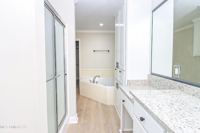 bathroom featuring vanity, crown molding, hardwood / wood-style floors, and independent shower and bath