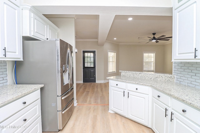 kitchen with tasteful backsplash, stainless steel fridge with ice dispenser, and white cabinets