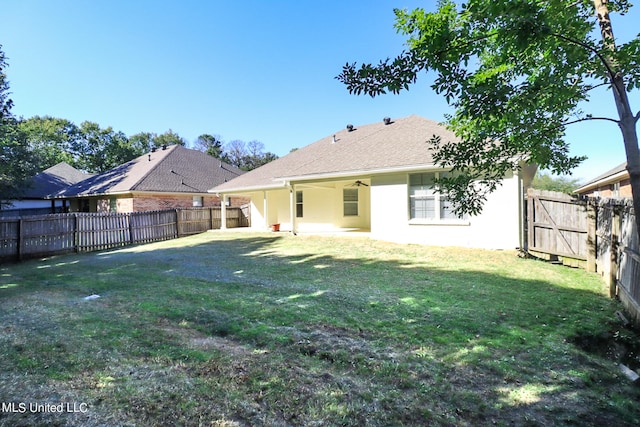 rear view of house with a patio and a lawn