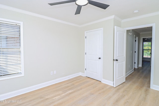 unfurnished bedroom featuring crown molding, light hardwood / wood-style flooring, a closet, and ceiling fan