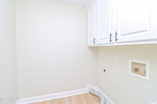 washroom featuring cabinets, washer hookup, light wood-type flooring, and electric dryer hookup