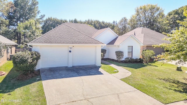 view of front of property featuring central AC, a front lawn, and a garage