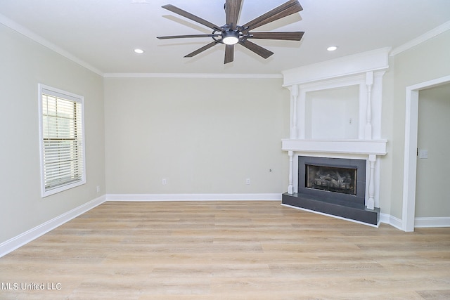 unfurnished living room featuring light hardwood / wood-style floors, ornamental molding, a fireplace, and ceiling fan