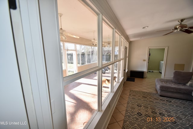 interior space with washer / clothes dryer, ceiling fan, and vaulted ceiling