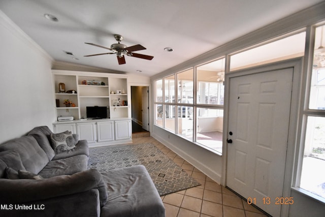 tiled living room with vaulted ceiling, ceiling fan, plenty of natural light, and ornamental molding