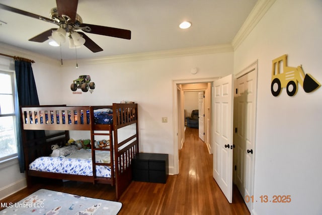 bedroom with ornamental molding, ceiling fan, and dark hardwood / wood-style floors