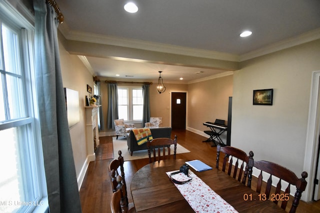 dining room with ornamental molding and dark hardwood / wood-style floors