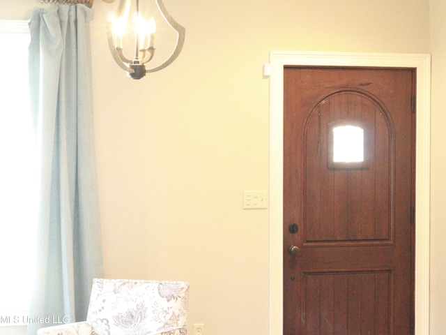 foyer featuring a chandelier