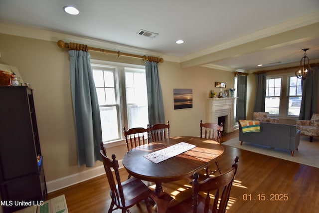 dining space featuring hardwood / wood-style flooring and crown molding