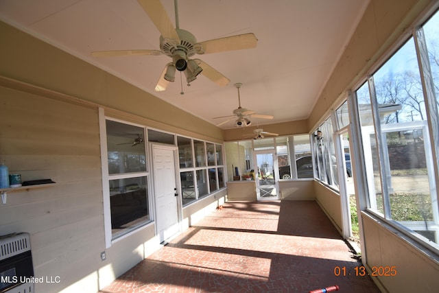 unfurnished sunroom featuring heating unit