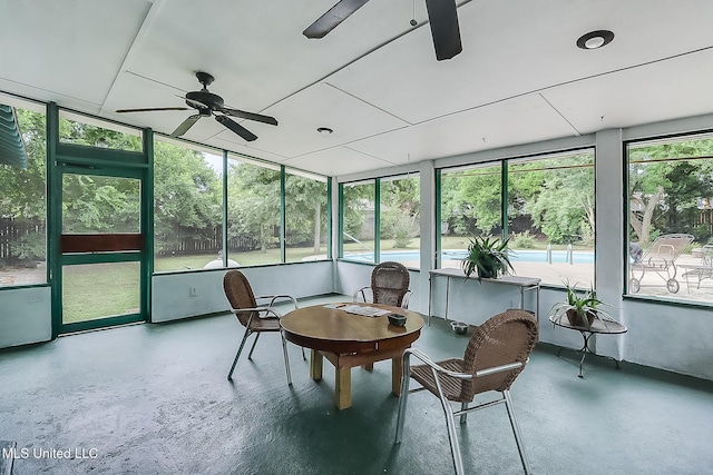 sunroom featuring a ceiling fan