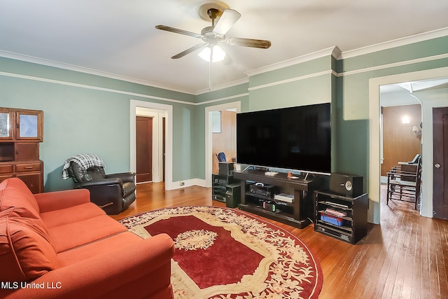 living area featuring ornamental molding, hardwood / wood-style flooring, and a ceiling fan