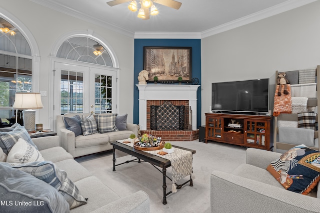 carpeted living room with crown molding, french doors, ceiling fan, and a brick fireplace