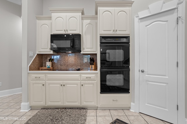 kitchen with black appliances, light tile patterned flooring, white cabinets, and backsplash