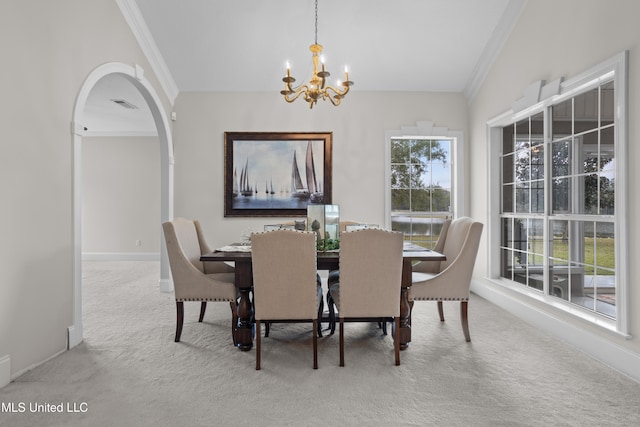 carpeted dining area with crown molding, vaulted ceiling, and an inviting chandelier