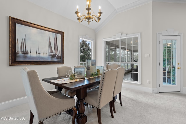 carpeted dining room with an inviting chandelier, crown molding, and vaulted ceiling