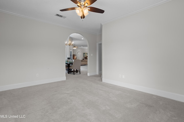 carpeted empty room featuring ceiling fan with notable chandelier and ornamental molding