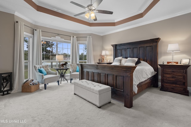 bedroom featuring a raised ceiling, light carpet, and ornamental molding