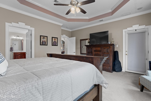 carpeted bedroom featuring ceiling fan, crown molding, and a tray ceiling