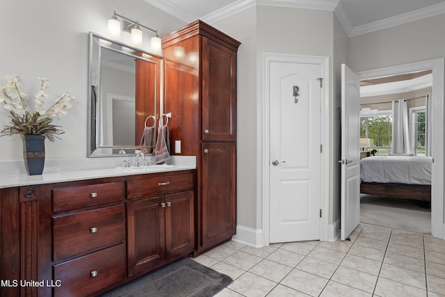 bathroom featuring tile patterned floors, crown molding, and vanity