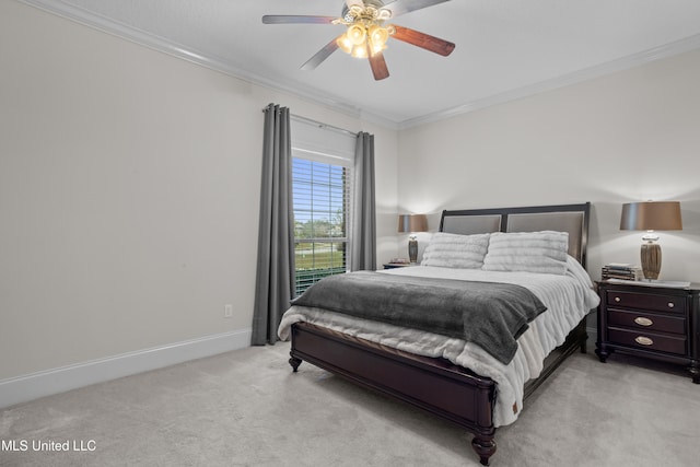 carpeted bedroom with ceiling fan and crown molding