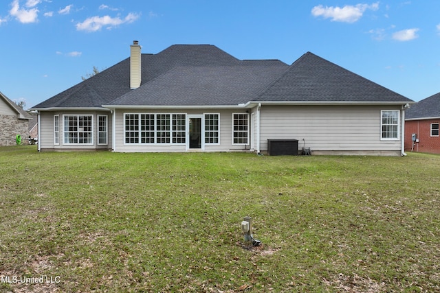 back of house with a lawn and central air condition unit