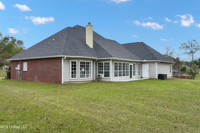 rear view of property with a lawn