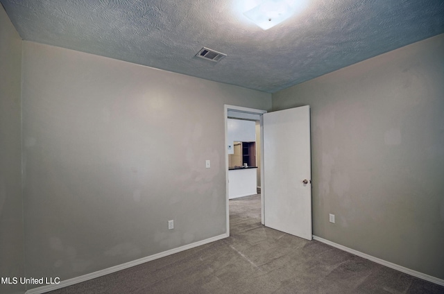 8962 Pleasant Hill Rd, Carthage, MS 39051 - carpeted spare room with baseboards and a textured ceiling