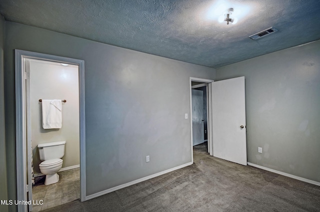 8962 Pleasant Hill Rd, Carthage, MS 39051 - unfurnished bedroom with ensuite bath, baseboards, carpet flooring, and a textured ceiling