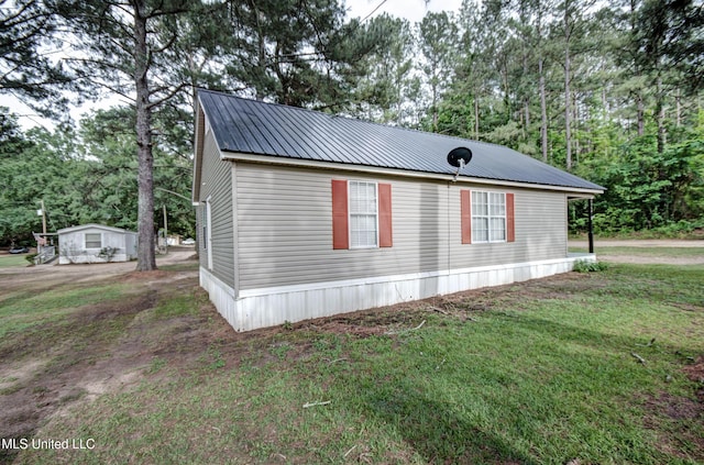 8962 Pleasant Hill Rd, Carthage, MS 39051 - view of property exterior featuring view of scattered trees, a lawn, and metal roof
