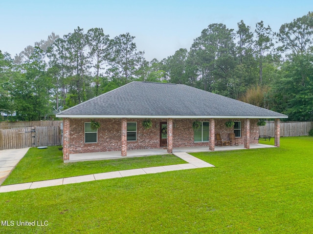 6811 Old Fort Bayou Rd, Ocean Springs, MS 39564 - ranch-style house with a shingled roof, a patio area, and brick siding
