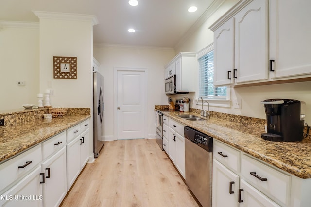 6811 Old Fort Bayou Rd, Ocean Springs, MS 39564 - kitchen with stainless steel appliances, a sink, light wood finished floors, crown molding, and light stone counters