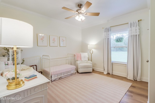 6811 Old Fort Bayou Rd, Ocean Springs, MS 39564 - bedroom featuring crown molding, light wood-type flooring, baseboards, a nursery area, and ceiling fan