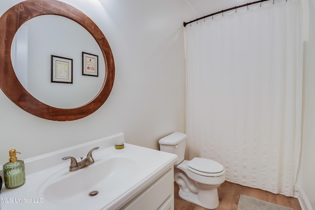 6811 Old Fort Bayou Rd, Ocean Springs, MS 39564 - full bathroom with wood finished floors, vanity, toilet, and a shower with curtain