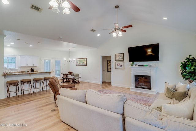 6811 Old Fort Bayou Rd, Ocean Springs, MS 39564 - living area featuring ceiling fan, light wood finished floors, a glass covered fireplace, vaulted ceiling, and recessed lighting