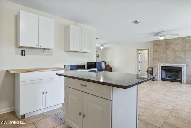 kitchen featuring white cabinetry, ceiling fan, and open floor plan