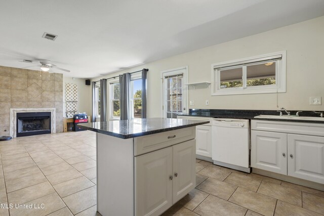 kitchen featuring visible vents, a sink, plenty of natural light, and dishwasher