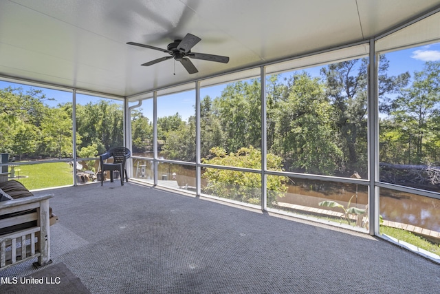 sunroom featuring a ceiling fan and a healthy amount of sunlight