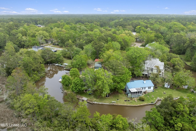 drone / aerial view featuring a forest view and a water view