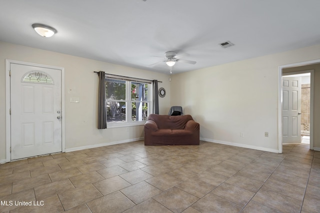 foyer with a ceiling fan, baseboards, visible vents, and tile patterned flooring