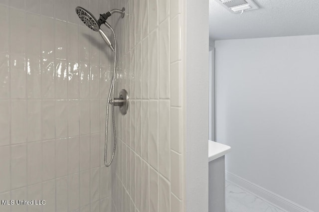 bathroom featuring vanity and a tile shower