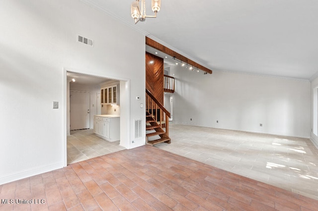 unfurnished living room with high vaulted ceiling, light wood-type flooring, ornamental molding, beamed ceiling, and a notable chandelier