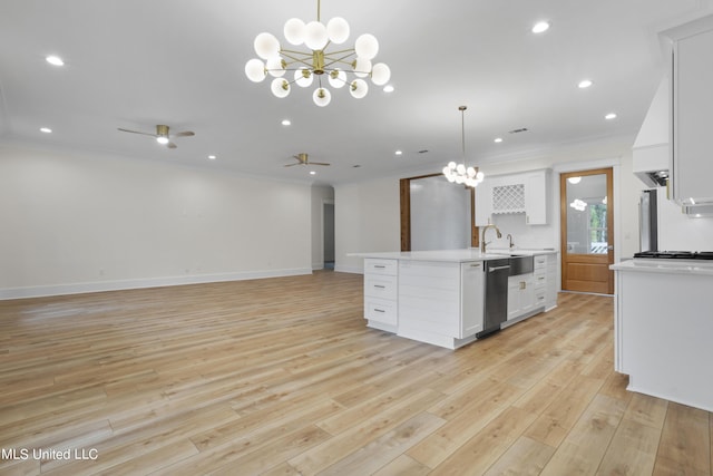 kitchen featuring light countertops, open floor plan, white cabinets, crown molding, and dishwasher