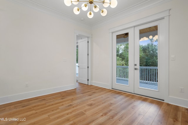 doorway to outside featuring french doors, ornamental molding, a chandelier, and light wood-type flooring